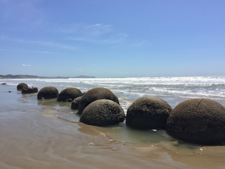 The boulders all lined up on the beach.