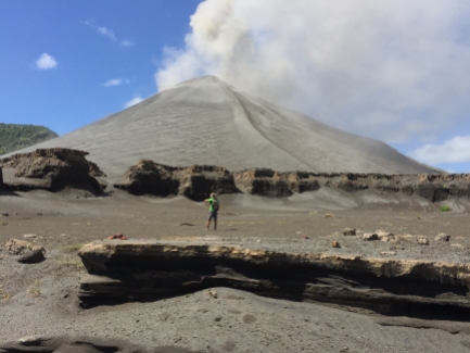 Yasur volcano in all its glory, as seen from a dried-up lake bed nearby
